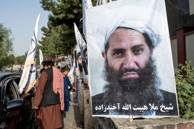 A poster of Taliban Supreme Leader Hibatullah Akhundzada is seen along a road in Kabul 