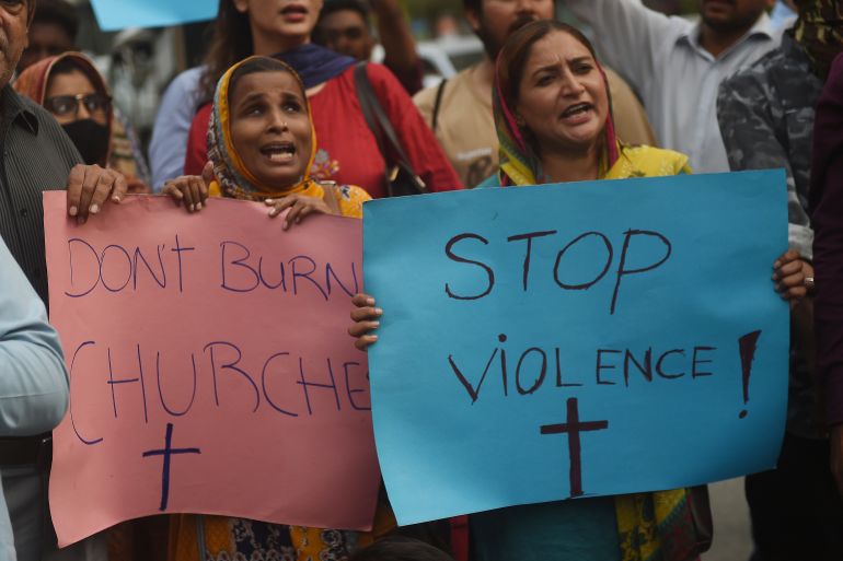 Civil society activists and members of the Christian community hold placards and shout slogans during a protest to condem the attacks to churches in eastern Pakistan, in Karachi