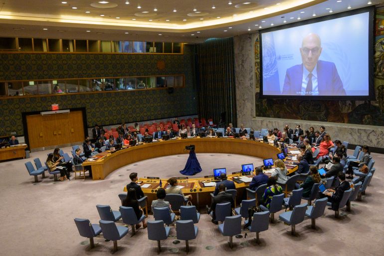 Volker Turk addresses the UN Security Council via video. His face is on a large screen.