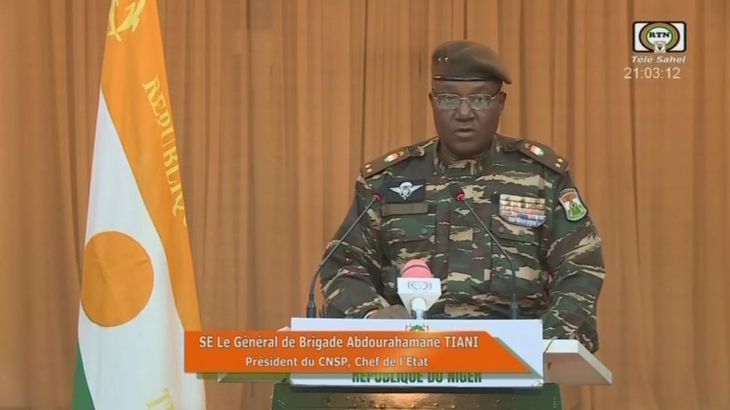 Niger's new military ruler General Abdourahamane Tiani reads a statement on national television