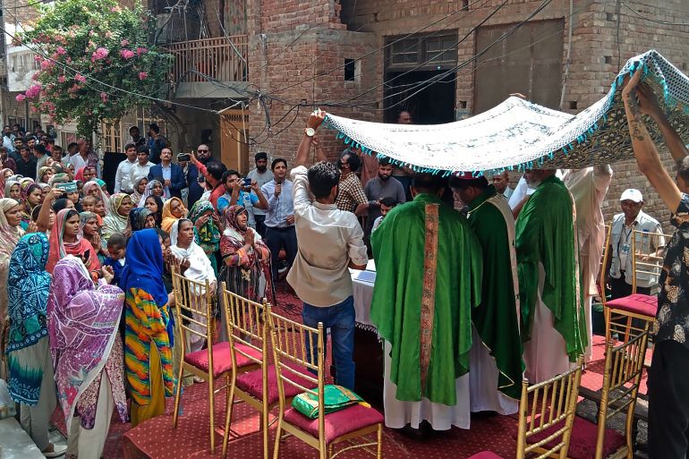 Christians attend a Sunday Service near the torched Saint John Church in Jaranwala on the outskirts of Faisalabad on August 20, 2023