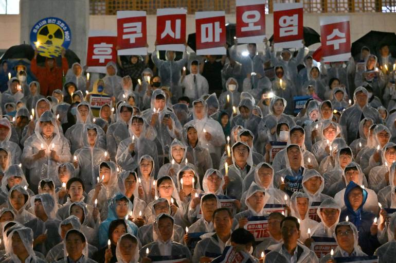 South Korean protesters hold electric candles at a vigil against the plan to release Fukushima water