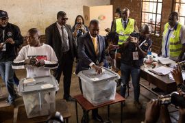 Opposition leader for the Citizens Coalition for Change (CCC) Nelson Chamisa (C) casts his ballot at a polling station during the presidential and legislative elections in Harare, on August 23, 2023