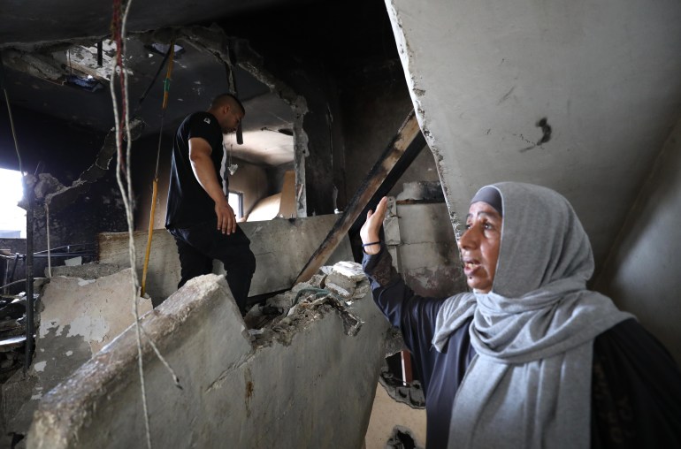 Raed Shallal and his mother Jamila inspect the remains of their building after Israeli forces destroyed it in the Balata refugee camp, Nablus on August 16 2023 in the occupied West Bank