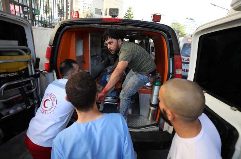 Injured Palestinians arrive at a hospital in Nablus after an Israeli raid in Beita