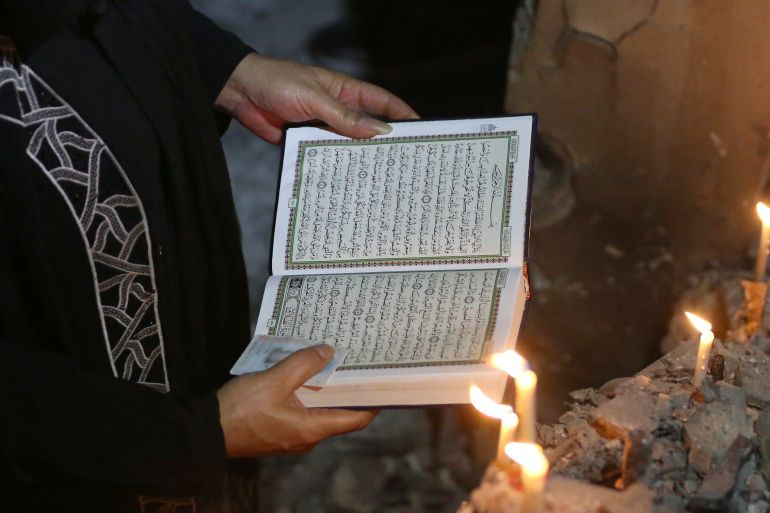A woman reads the Quran, Islam's holy book