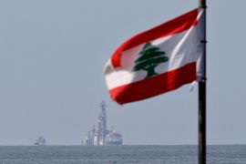 Lebanese flag in foreground, sea and ship in background