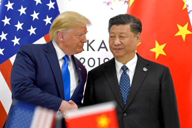 FILE - In this June 29, 2019, file photo, U.S. President Donald Trump, left, shakes hands with Chinese President Xi Jinping during a meeting on the sidelines of the G-20 summit in Osaka, western Japan. The ongoing sharp deterioration in U.S.-China ties poses risks to both countries and the rest of the world. With the U.S. presidential campaign heating up, all bets are that relations with China will only get worse. At stake are global trade, technology and security. (AP Photo/Susan Walsh, File)