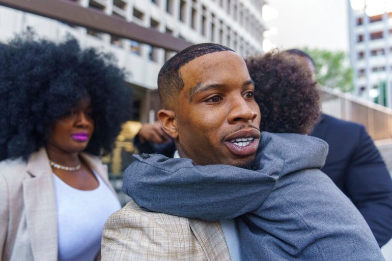 Rapper Tory Lanez, 30, walks out of the courthouse while holding his 5-year-old son Kai'Lon, Tuesday, Dec. 13, 2022, in Los Angeles. Megan Thee Stallion took the stand Tuesday and told jurors that Lanez fired five shots at her feet, yelled at her to dance and wounded her as she tried to walk away from him in the Hollywood Hills more than two years ago. The Canadian rapper has pleaded not guilty to discharging a firearm with gross negligence, assault with a semiautomatic firearm and carrying a loaded, unregistered firearm in a vehicle. (AP Photo/Damian Dovarganes)