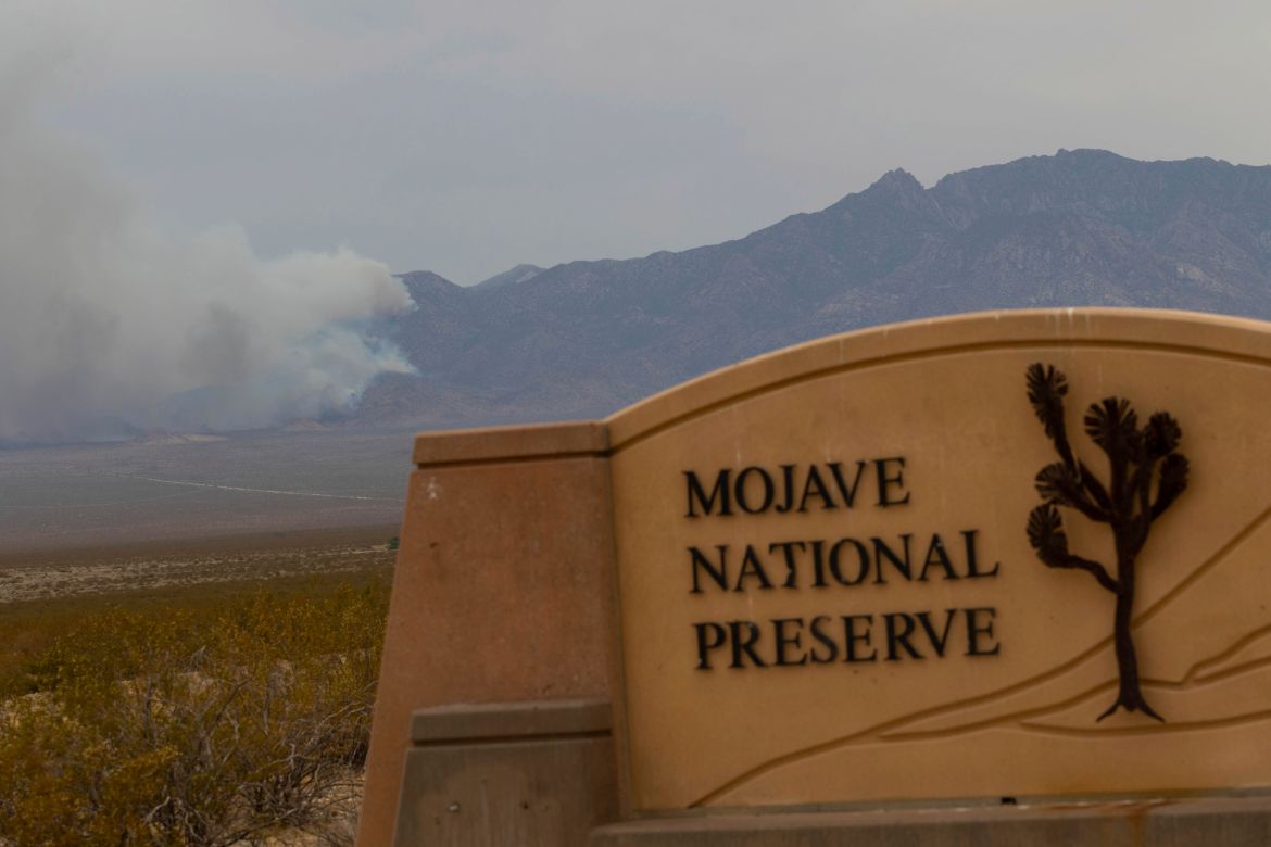 Smoke rises from a mountain range during the York Fire