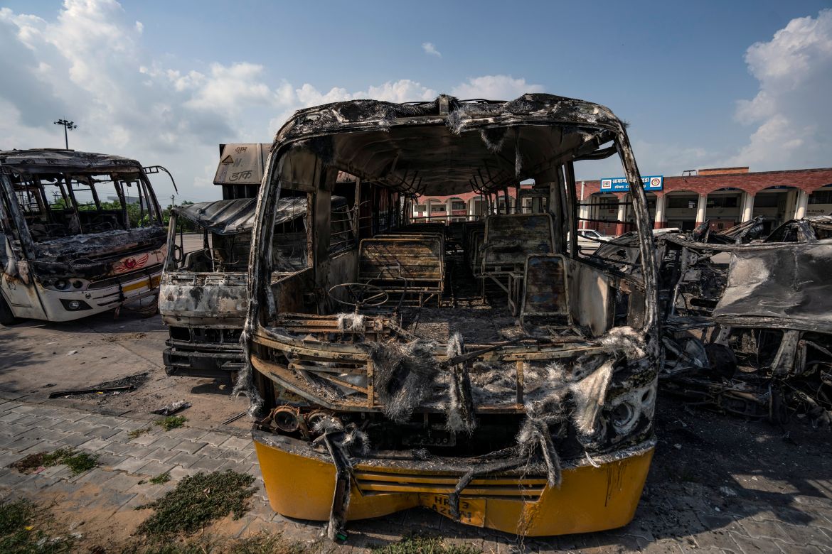 Burnt vehicles stand in a transport yard in Nuh in Haryana state, India
