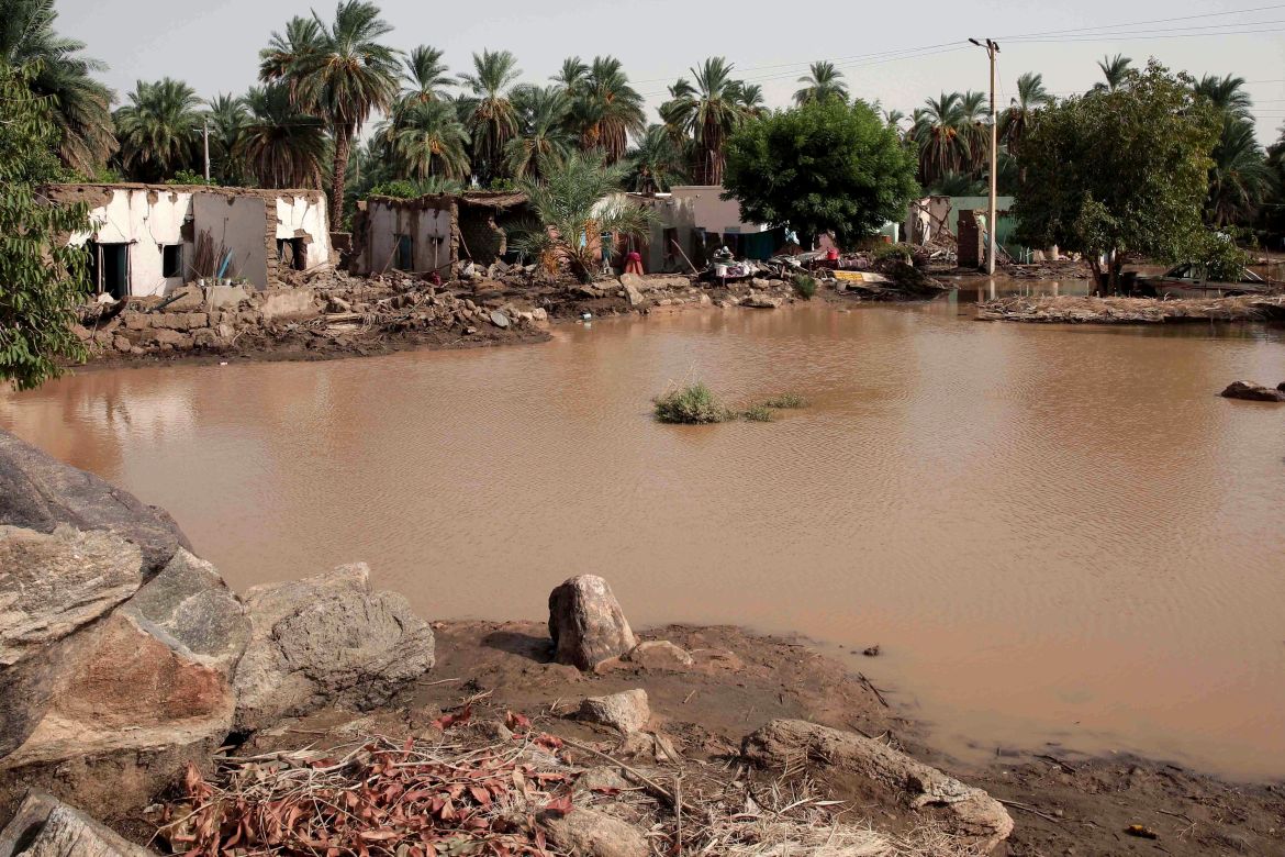 Floodwaters surround houses, many of them badly damaged, in a village near the city of Meroe