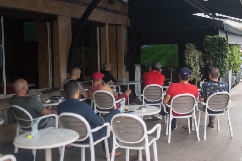 Moroccan men watch a soccer game in a coffee shop between Morocco and France
