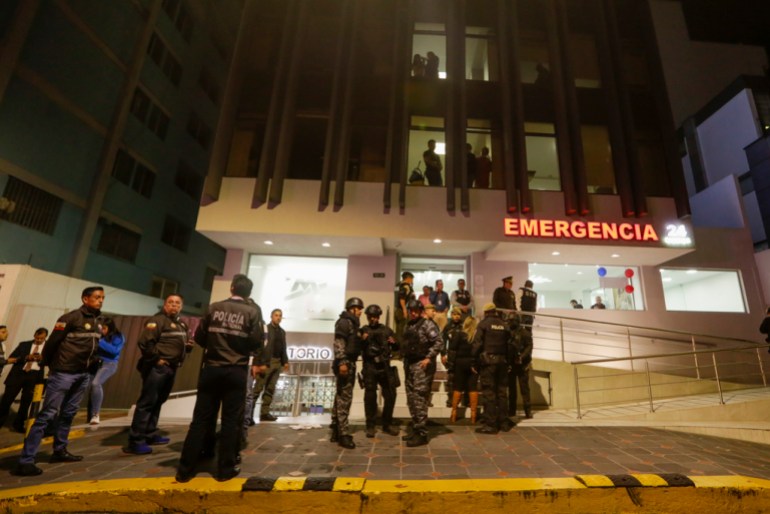 Police guard the hospital where several of the injured were taken after an attack against presidential candidate Fernando Villavicencio in Quito, Ecuador, Wednesday, Aug. 9, 2023. Villavicencio was killed as he entered a vehicle after a campaign rally, outside a school in Quito. (AP Photo/Juan Diego Montenegro)