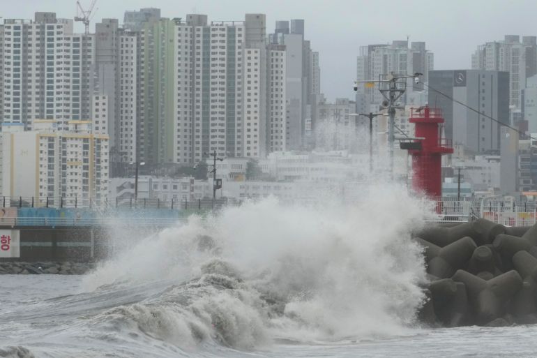 High waves crash a shore as the tropical storm named Khanun approaches to the Korean Peninsular, in Busan, Thursday, Aug. 10, 2023. A strong tropical storm blew ashore in South Korea on Thursday morning, dumping heavy rain and pummeling its southern regions after thousands of people were evacuated. (AP Photo/Ahn Young-joon)