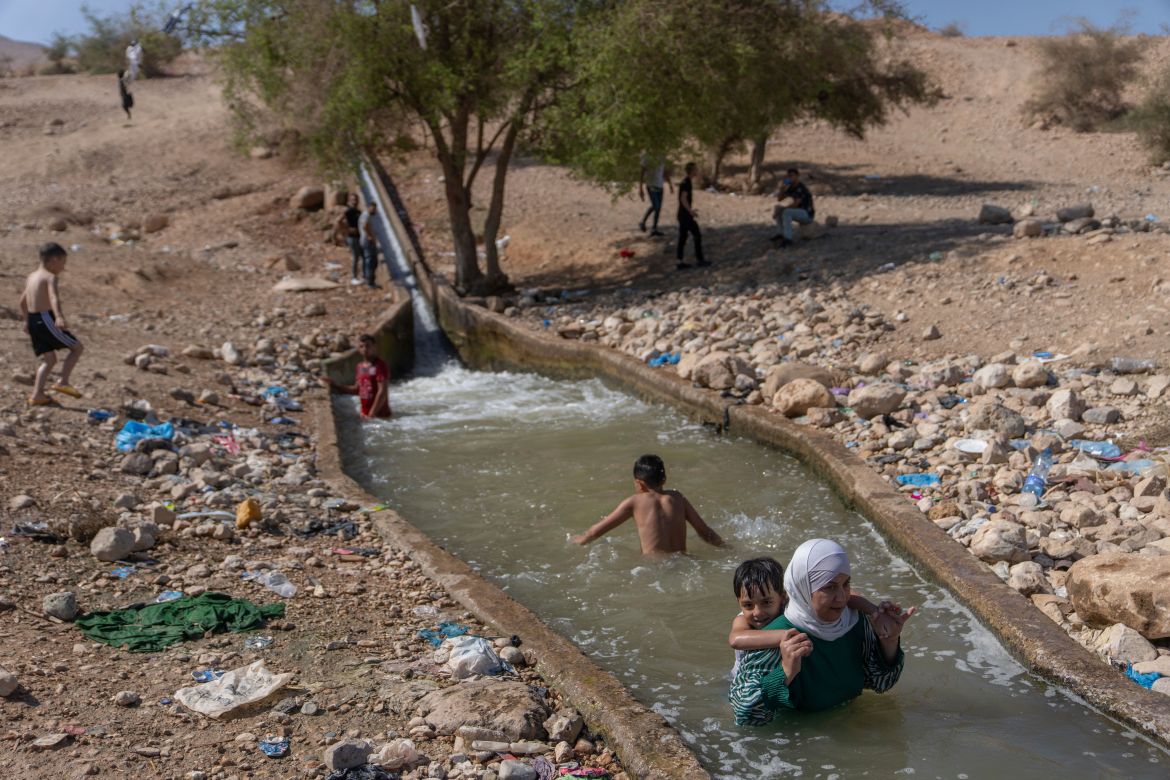 Palestinians cool down in a spring in Auja in the Jordan Valley