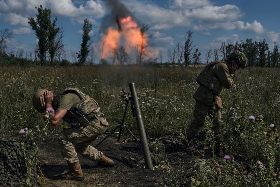 Ukrainian soldiers fire a mortar towards Russian positions at the front line, near Bakhmut, Donetsk region, Ukraine