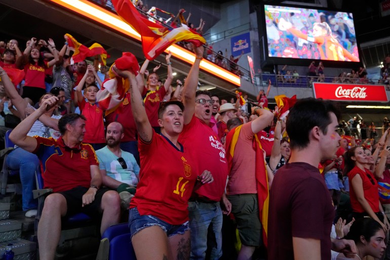 Spanish fans cheer in front of large screens after Spain's Olga Carmona scored the opening goal during the Women's World Cup final soccer match between Spain and England in Madrid, Spain, Sunday, Aug. 20, 2023