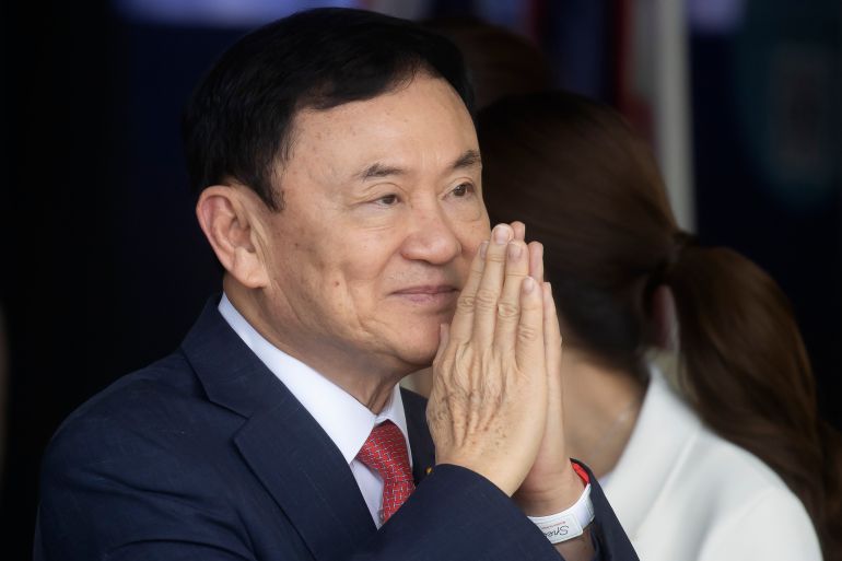 Thaksin Shinawatra makes the wai gesture as he returns to Thailand