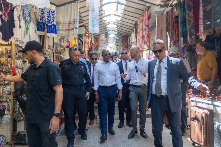 Eric Adams, in the centre of his entourage — including security —, walks through the tight pathways of Jerusalem's Old City.
