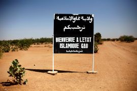 A sign on the northern road exiting in Gao, Northern Mali, reads "welcome to the islamic state of Gao on Jan. 30, 2013.