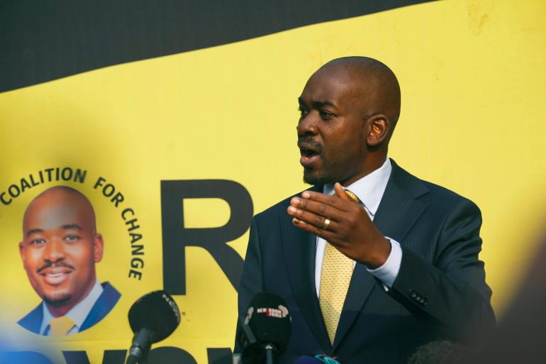 Zimbabwe opposition leader Nelson Chamisa speaking at a press conference in Harare. He is making a point with his left hand, and standing on front of a yellow backdrop.