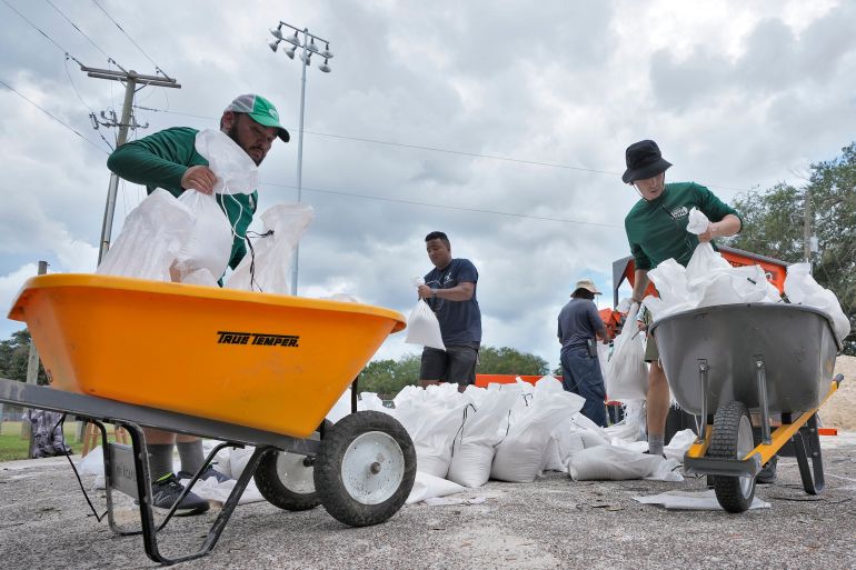 People in Tampa, Florida, prepare sand bags as a major storm approaches
