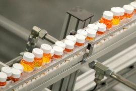 FILE- Bottles of medicine ride on a belt at a mail-in pharmacy warehouse in Florence, N.J., July 10, 2018. President Joe Biden's administration will announce on Tuesday, Aug. 29, 2023, the first prescription drugs being targeted by the U.S. government for price negotiations as part of an effort to lower Medicare costs. (AP Photo/Julio Cortez, File)