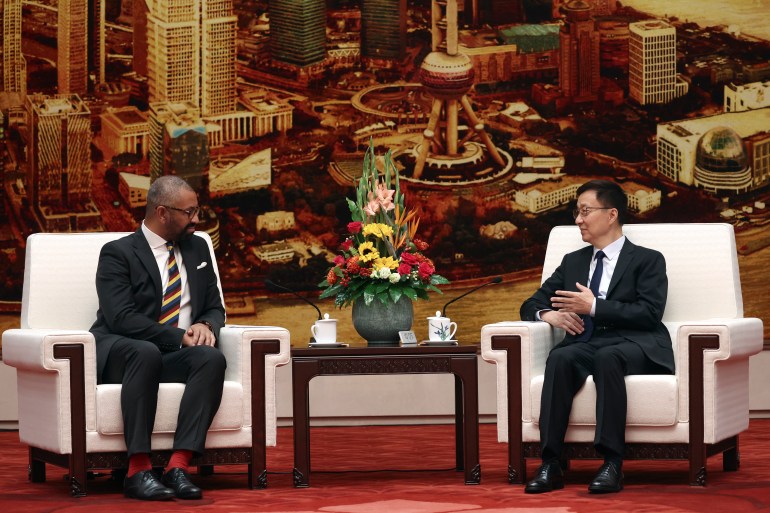 British Foreign Secretary James Cleverly, left, and Chinese Vice President Han Zheng attend a meeting at the Great Hall of the People in Beijing