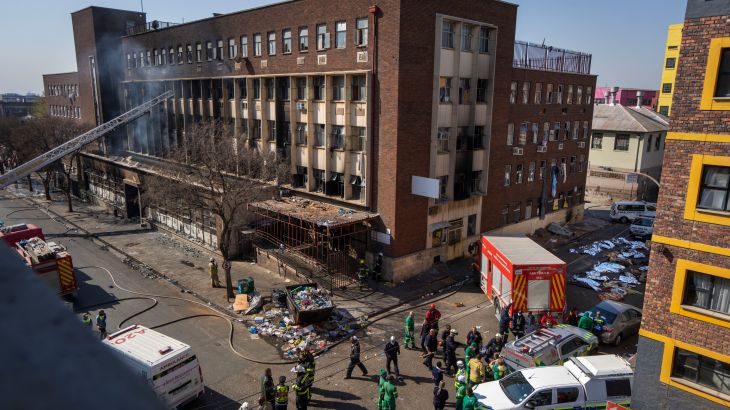 Medics and emergency works at the scene of a deadly blaze in downtown Johannesburg