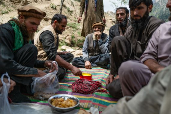Miners take a lunch break outside their mine near Paroon, in Nuristan province.