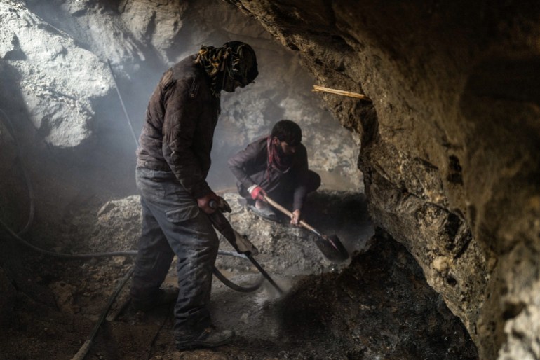 Miners work inside a tourmaline mine near Paroon, in the remote province of Nuristan