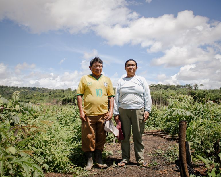 Telma Macuxi and her husband pose in front of their field in Brazil 