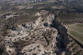 In an aerial view, damaged land is seen at an olive grove in the aftermath of a deadly earthquake on February 18, 2023 in Tepehan, Turkey