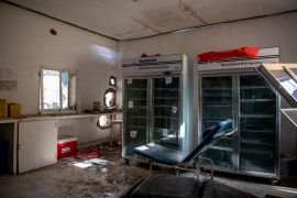 Sunlight shines through holes blown into the Las Anod General Hospital's destroyed blood bank, where refrigerators lie empty
