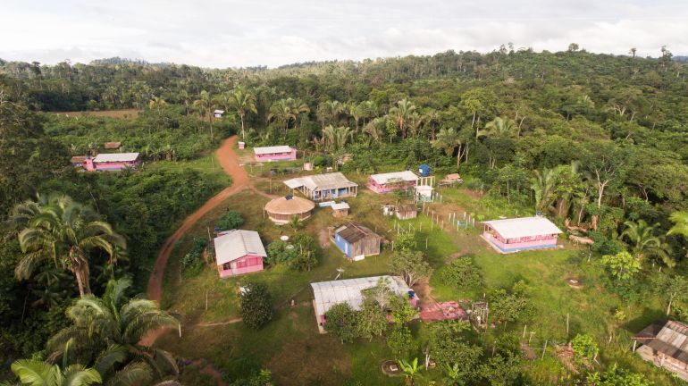 An aerial view of a small town in the Amazon rainforest.