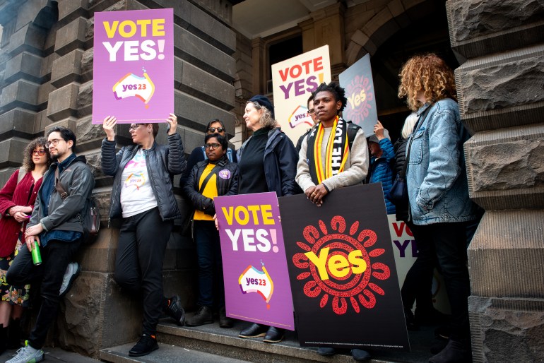 People standing outside Melbourne Town Hall to show their support for the 'yes' campaign. They are carrying a variety of placards reading 'yes'