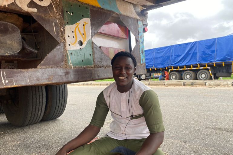 Badamasi Mohammed, a freight truck driver sits beside his truck at the Jibiya border between Nigeria and Niger on August 7, 2023 due to closure of borders between both countries after July 26 coup