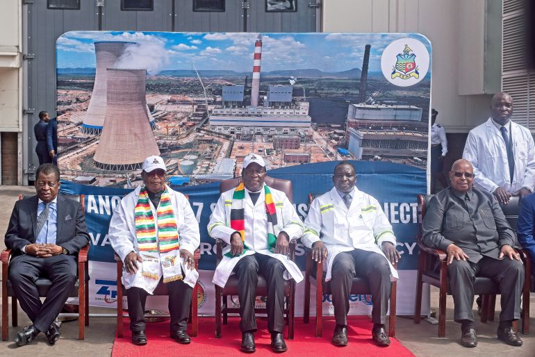 Zimbabwe's President Emmerson Mnangagwa (centre) sits for a picture at the commissioning of two additional power units at the Hwange Thermal Power Station, Zimbabwe