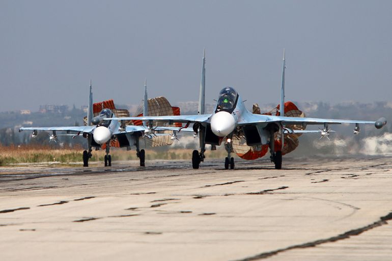 A picture taken on October 3, 2015 shows Russian Sukhoi Su-30 SM jet fighters landing on a runway at the Hmeimim airbase in the Syrian province of Latakia. AFP PHOTO / KOMSOMOLSKAYA PRAVDA / ALEXANDER KOTS *RUSSIA OUT* (Photo by ALEXANDER KOTS / KOMSOMOLSKAYA PRAVDA / AFP) / RUSSIA OUT