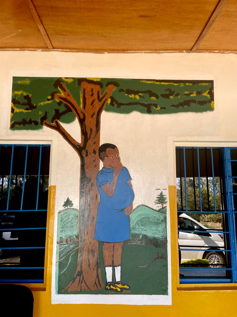 Artwork depicting a pregnant Rwandan teen outside the community center in Karongi district of Rwanda 
