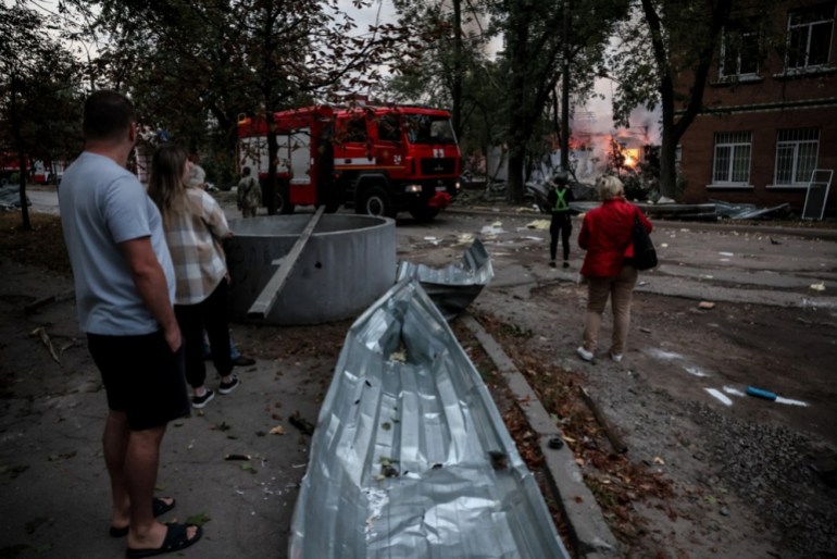 epa10873536 Local residents stand near the site of a missile strike on a residential area, in Kyiv, Ukraine, 21 September 2023. "Damage was recorded in Darnytskyi, Solomyanskyi, Shevchenkivskyi districts in Kyiv as a result of falling missiles’ pieces. Fires broke out in Darnytskyi District. Seven people were wounded, including a child." says Ihor Klymenko, Ukraine's Minister of Internal Affairs EPA-EFE/OLEG PETRASYUK 28899