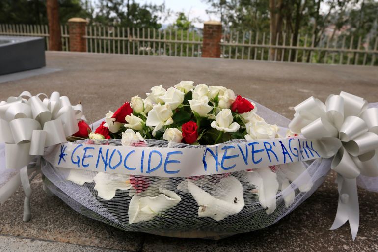 A bouquet of flowers tied with a ribbon showing the message "Genocide Never Again" is pictured in the Kigali Genocide Memorial grounds in the capital Kigali April 2, 2014.