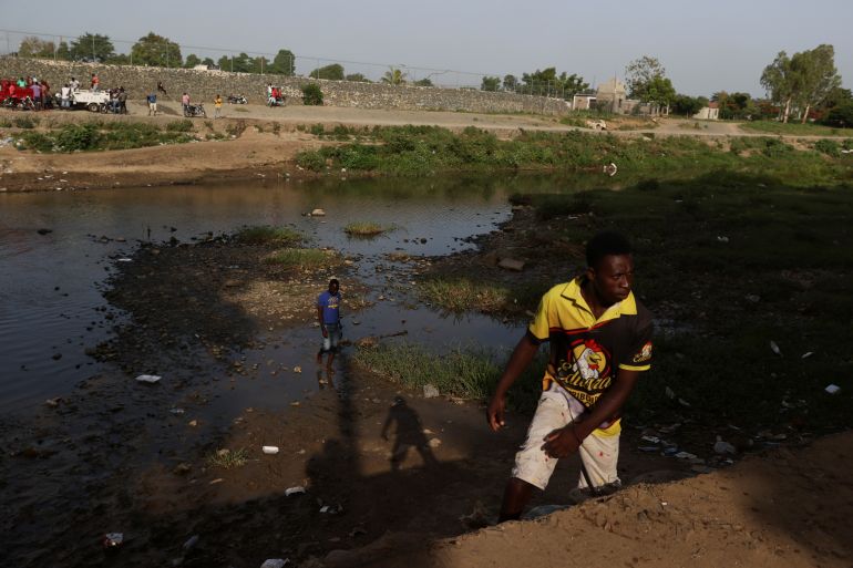 Haitians are seen on the banks of the Massacre River between Haiti and the Dominican Republic