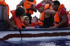 Eighteen people on a small wooden boat near the Italian island of Lampedusa, in the Mediterranean Sea, in 2021 [File: Juan Medina/Reuters]