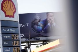 Gasoline prices are displayed at a Shell gas station in front of a billboard advertising HBO's "Last Week Tonight with John Oliver" in Los Angeles, California, U.S., March 10, 2022. Picture taken March 10, 2022. REUTERS/Bing Guan