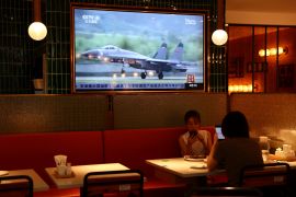 A TV screen showing news footage of military exercises near Taiwan by the Chinese People&#39;s Liberation Army&#39;s Eastern Theatre Command, at a restaurant in Beijing, China, in August 2022 [Tingshu Wang/Reuters]