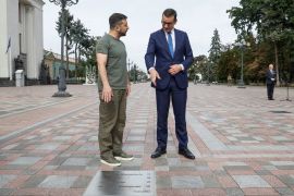 Ukraine’s President Volodymyr Zelenskiy and Polish Prime Minister Mateusz Morawiecki stand next to a plaque with Morawiecki’s name on the Alley of Bravery during a joint news briefing with Latvian President Egils Levits, amid Russia’s attack on Ukraine, in Kyiv, Ukraine September 9, 2022.  REUTERS/Valentyn Ogirenko