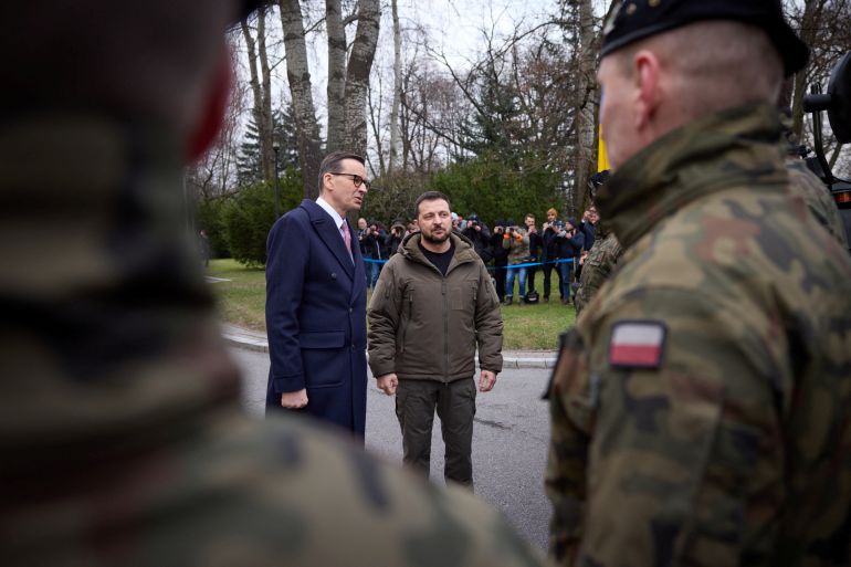 Ukrainian President Volodymyr Zelenskiy and Polish Prime Minister Mateusz Morawiecki speak to polish service members during an overview of Rosomak armoured personnel carriers in Warsaw, Poland April 5, 2023. Ukrainian Presidential Press Service/Handout via REUTERS ATTENTION EDITORS - THIS IMAGE HAS BEEN SUPPLIED BY A THIRD PARTY.