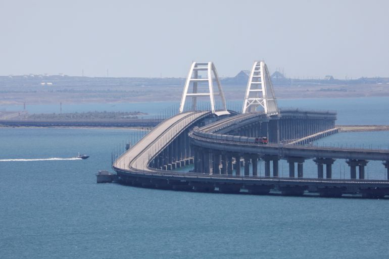 A train moves along the Crimean Bridge, a section of which was damaged by an alleged overnight attack, as seen from the city of Kerch, Crimea, July 17, 2023. REUTERS/Alexey Pavlishak